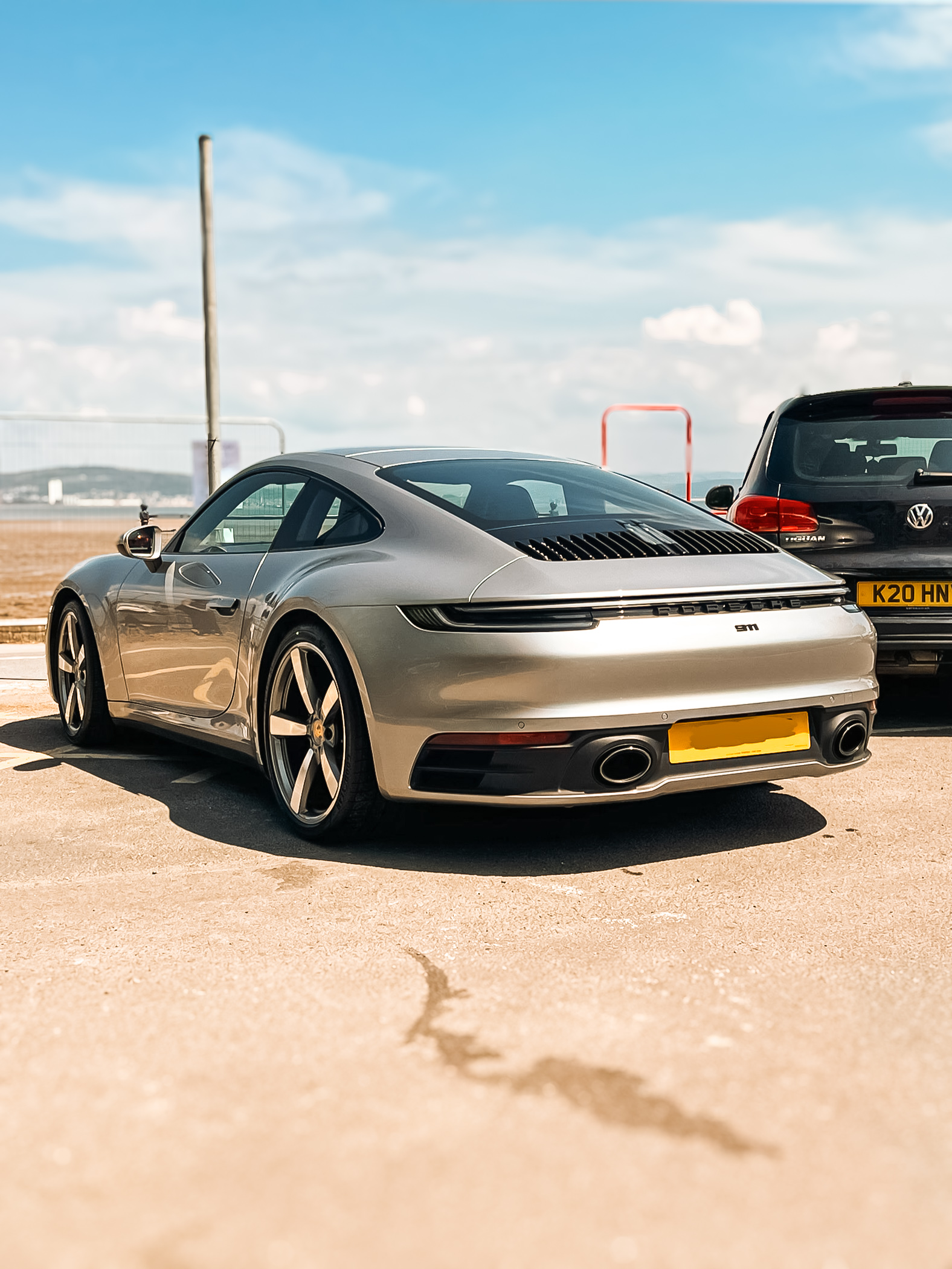 Silver Porsche finished beside the coast